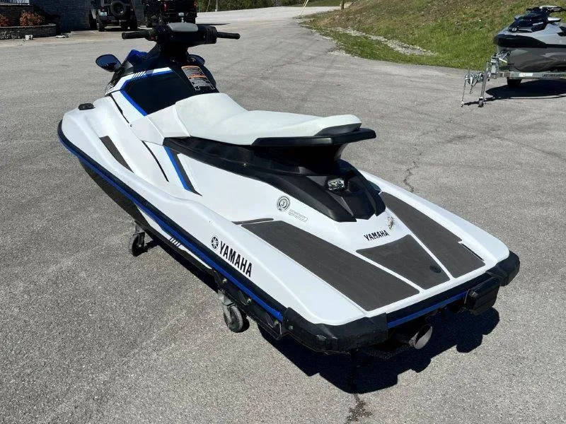 Slide: The Image of 2017 Yamaha WaveRunner EX Sport jet ski on pavement, white and blue design. - 4
