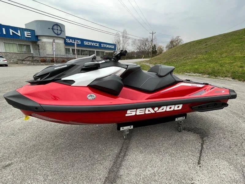 Slide: The Image of 2024 Sea-Doo RXP-X 325 Sound jet ski in vibrant red, parked outdoors. - 13