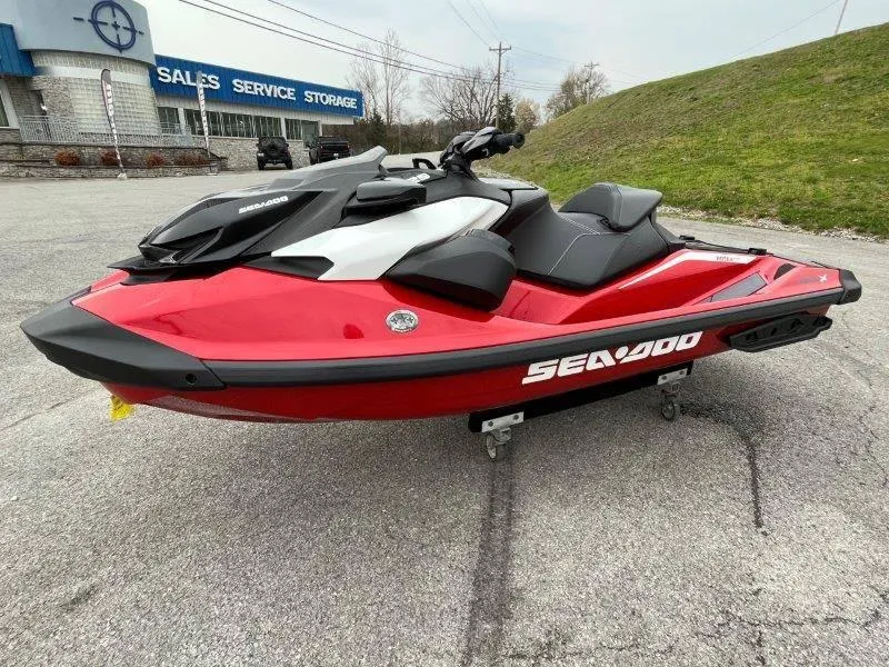 Slide: The Image of 2024 Sea-Doo RXP-X 325 Sound jet ski in red, parked outdoors. - 14