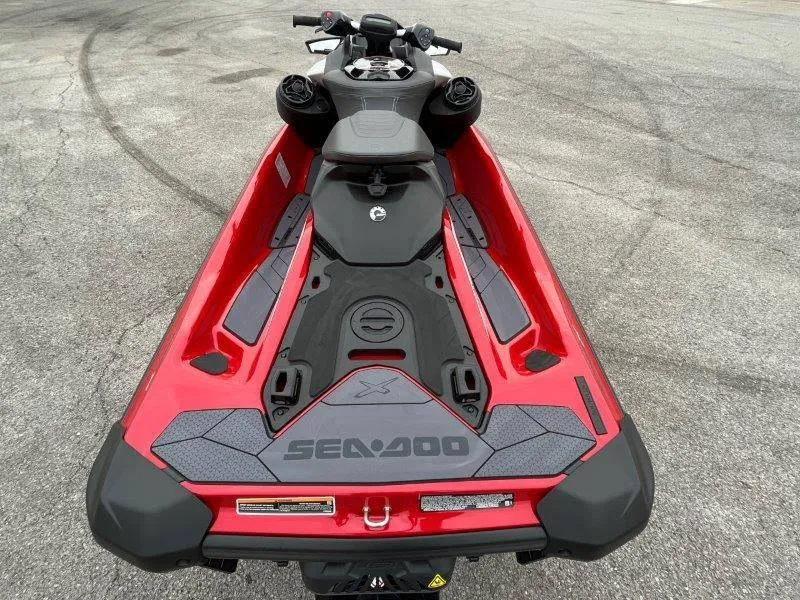 Slide: The Image of 2024 Sea-Doo RXP-X 325 Sound, red and black jet ski, rear view. - 16