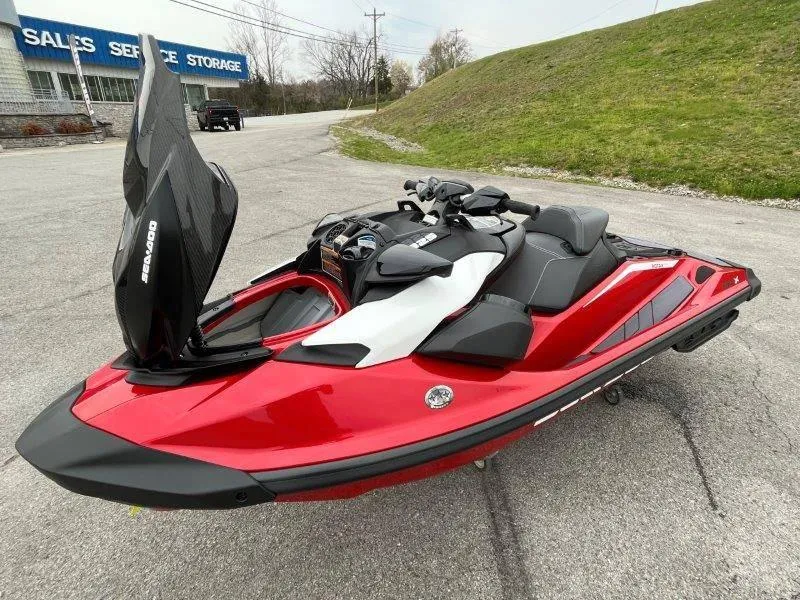 Slide: The Image of 2024 Sea-Doo RXP-X 325 Sound jet ski in vibrant red, parked outdoors. - 22