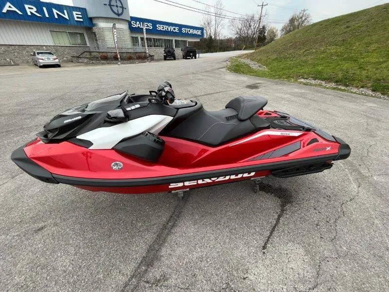 Slide: The Image of 2024 Sea-Doo RXP-X 325 Sound jet ski in vibrant red, parked outdoors. - 24