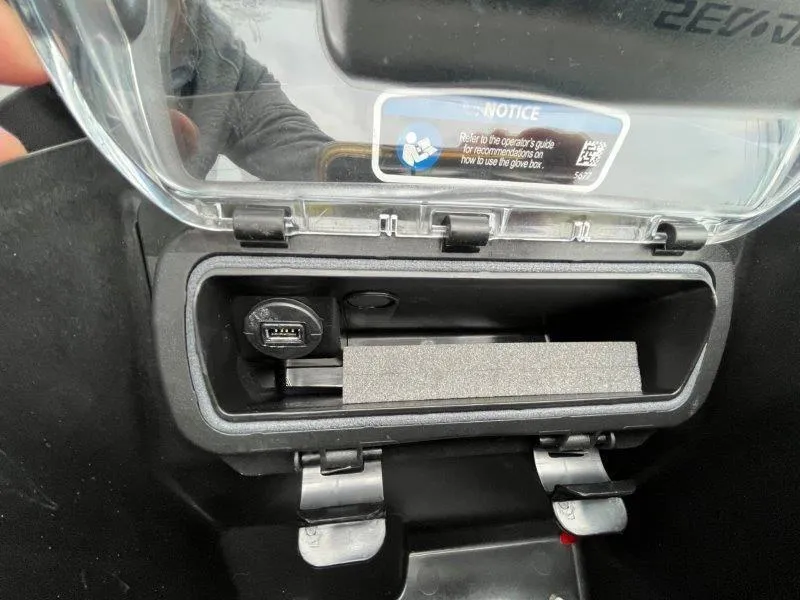 Slide: The Image of 2024 Sea-Doo RXP-X 325 Sound glove box with USB port and storage compartment. - 26