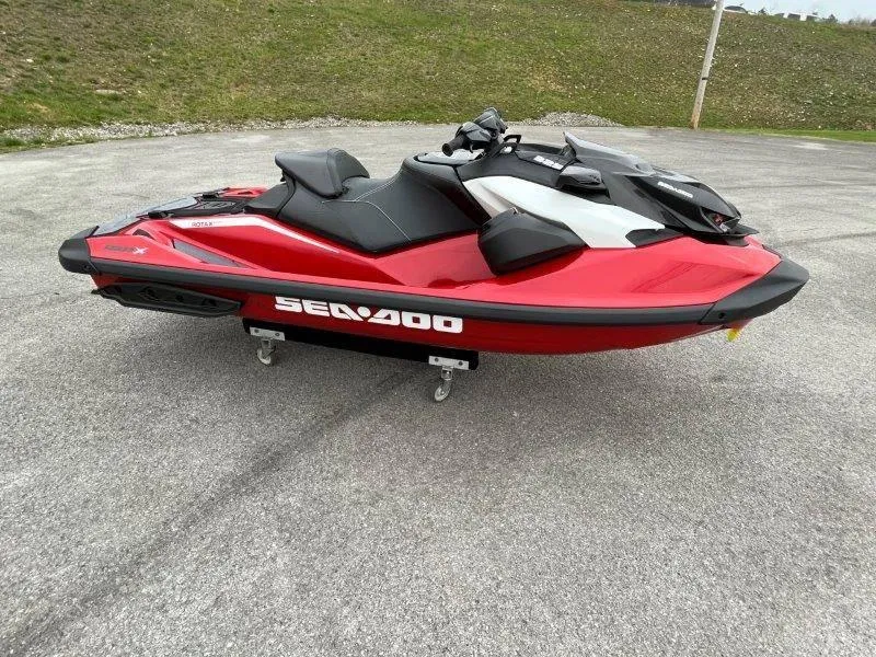 Slide: The Image of 2024 Sea-Doo RXP-X 325 Sound jet ski in vibrant red on a paved surface. - 3