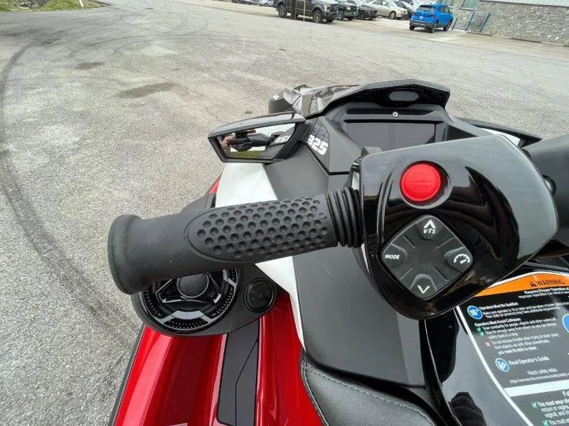 Slide: The Image of 2024 Sea-Doo RXP-X 325 Sound handlebar with controls, parked on asphalt. - 35