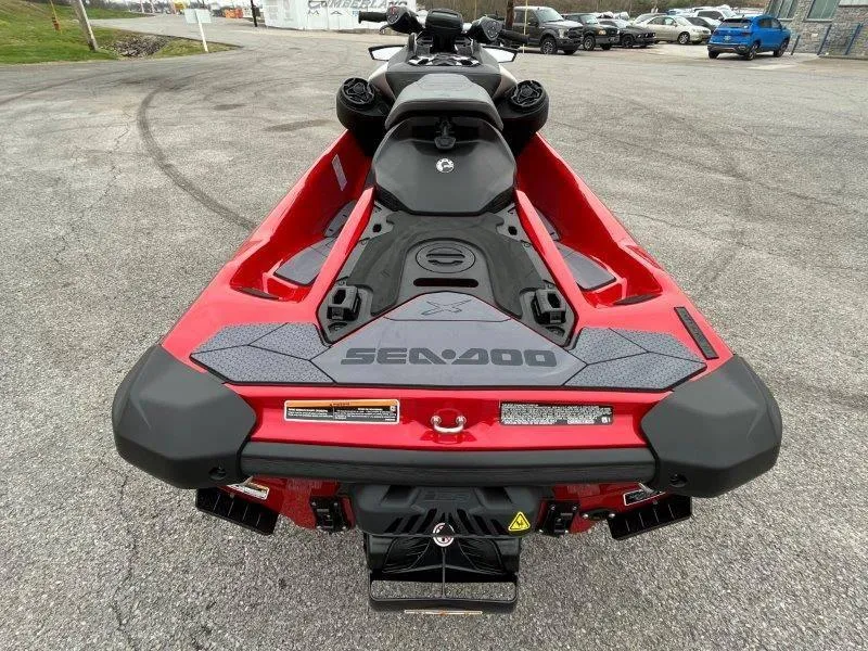 Slide: The Image of 2024 Sea-Doo RXP-X 325 Sound, red jet ski, rear view on pavement. - 4