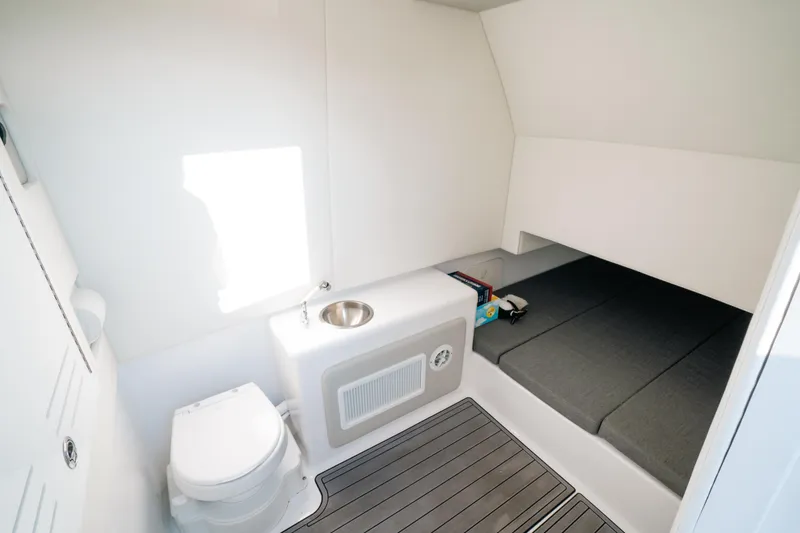 Slide: The Image of 2023 Front Runner 39 Center Console cabin with toilet, sink, and sleeping area. - 13
