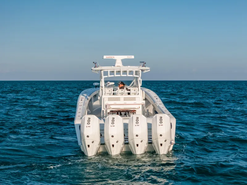 Slide: The Image of 2023 Front Runner 39 Center Console boat with four engines on open sea. - 24