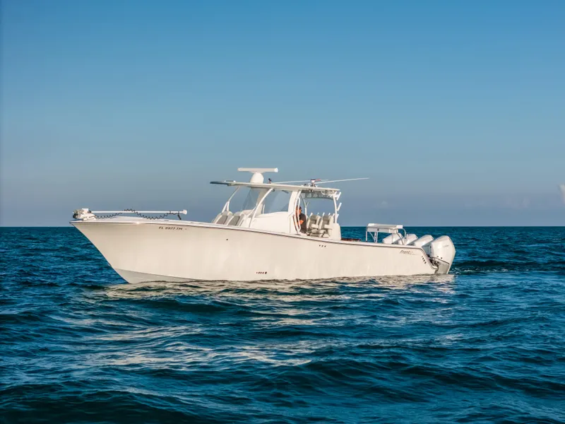 Slide: The Image of 2023 Front Runner 39 Center Console boat cruising on open water under clear blue sky. - 30