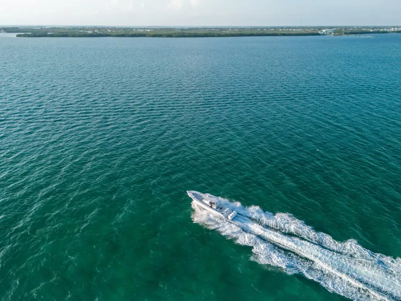 Slide: The Image of Aerial view of 2023 Front Runner 39 Center Console speeding on open water. - 33