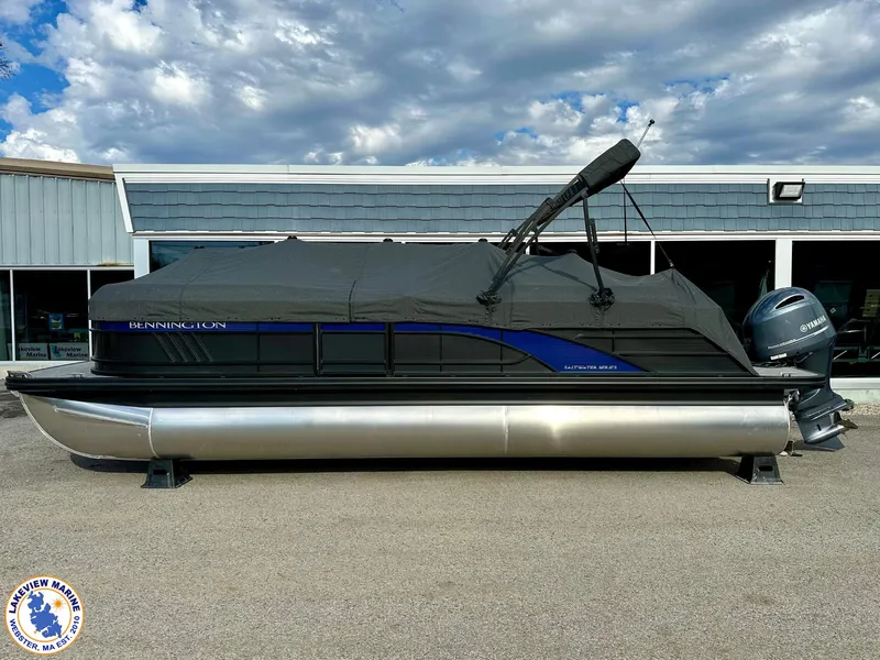 Slide: The Image of 2024 Bennington 23 LXFB pontoon boat with cover, parked outdoors. - 15