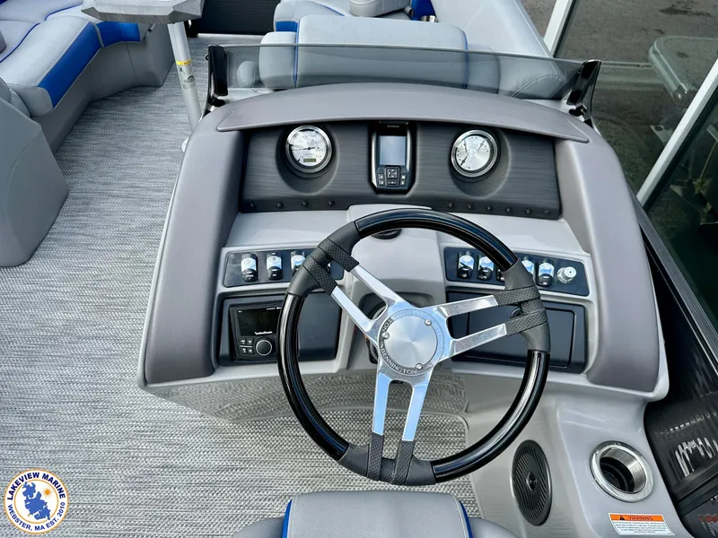 Slide: The Image of 2024 Bennington 23 LXFB boat dashboard with steering wheel and gauges. - 8