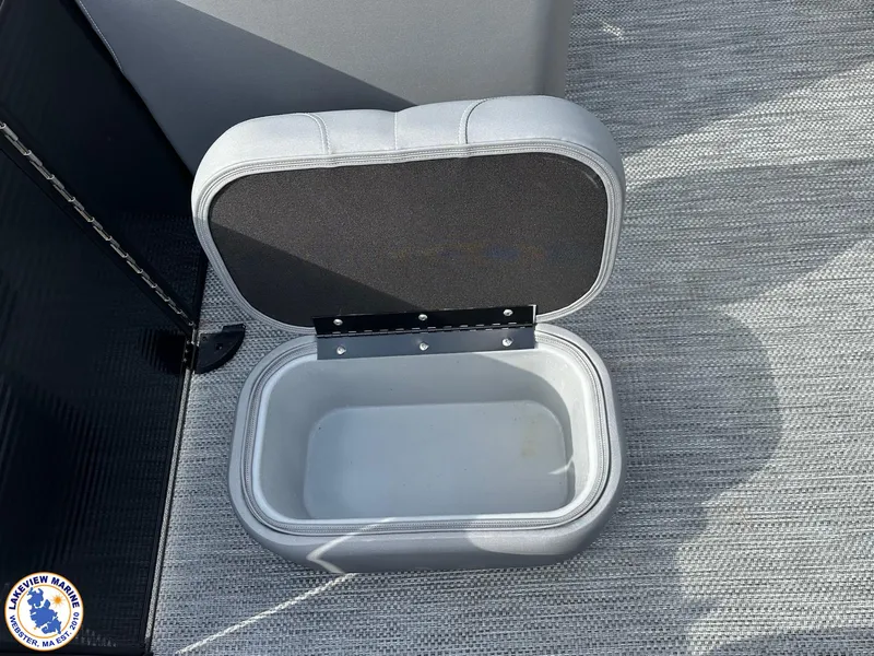 Slide: The Image of Open storage compartment on 2024 Bennington 23 LXFB boat, featuring gray interior. - 9