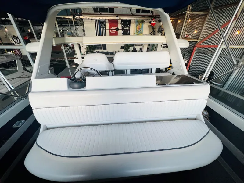 Slide: The Image of 1994 Carver 350 Aft Cabin interior with white seating in a marina setting. - 11