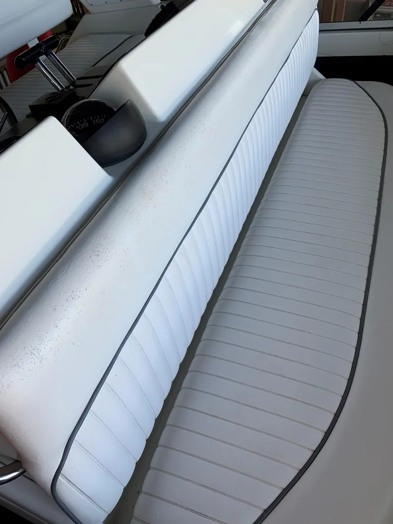 Slide: The Image of 1994 Carver 350 Aft Cabin boat seating with white upholstery and sleek design. - 12