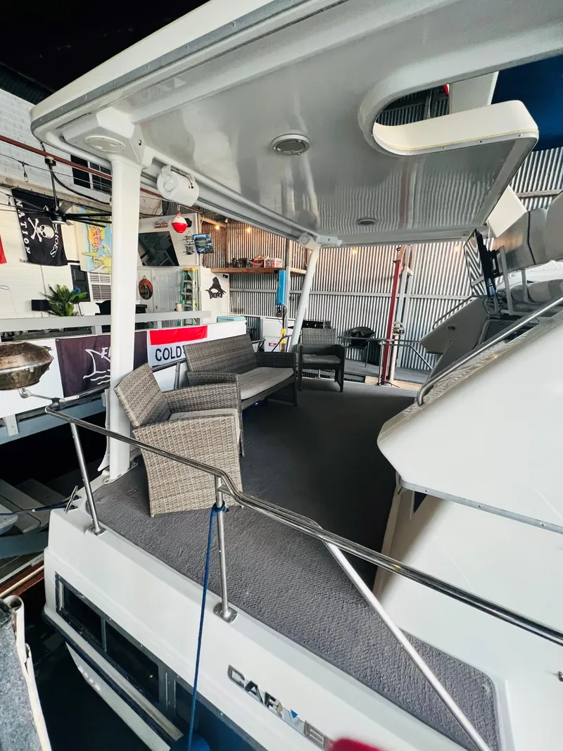 Slide: The Image of 1994 Carver 350 Aft Cabin yacht with spacious deck and seating area. - 17