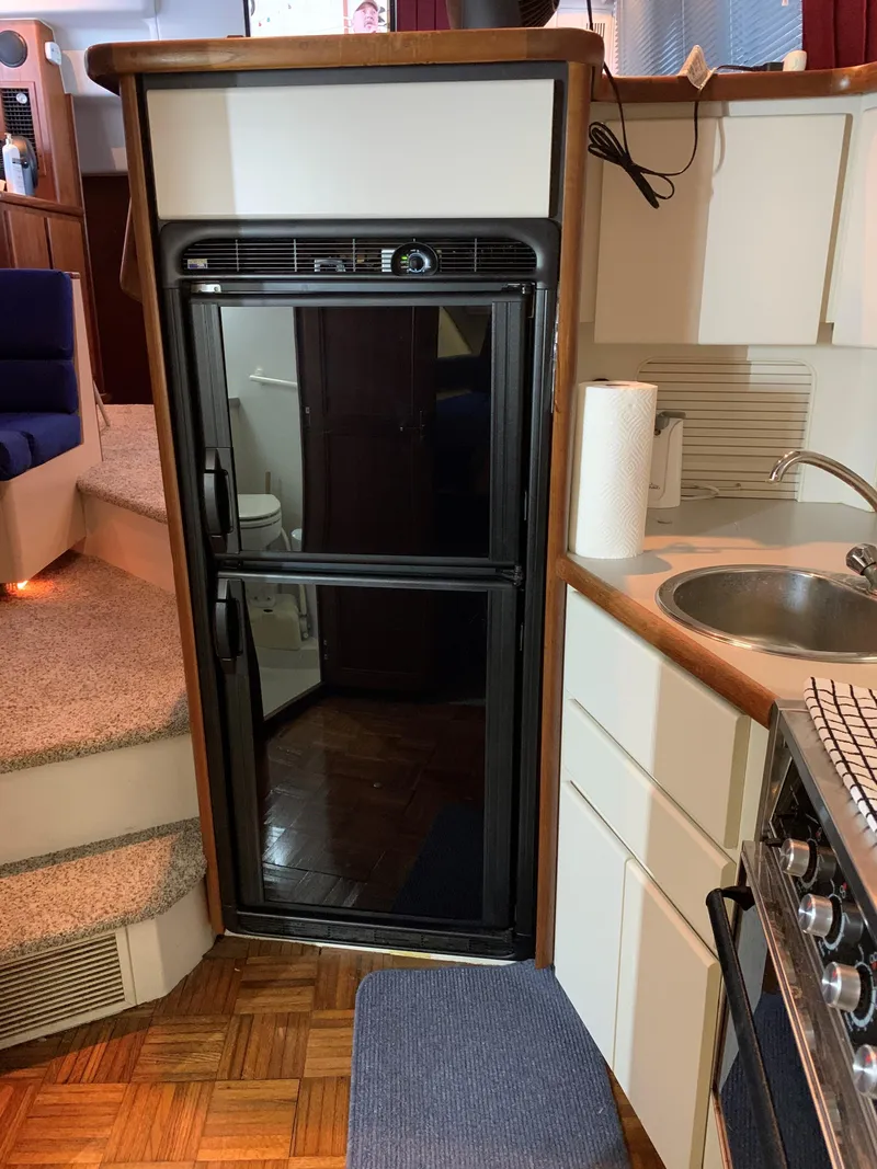 Slide: The Image of 1994 Carver 350 Aft Cabin kitchen with fridge, sink, and stove. - 27