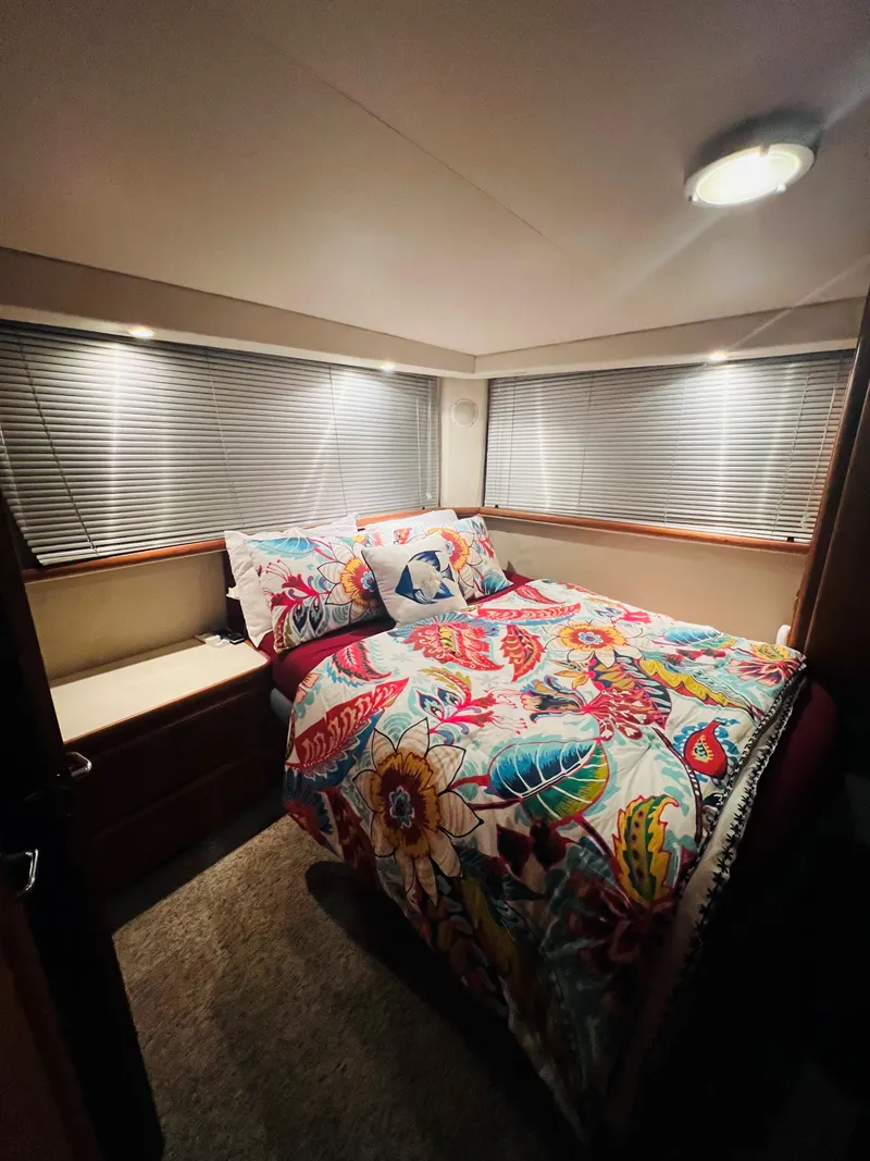 Slide: The Image of Cozy bedroom in 1994 Carver 350 Aft Cabin with vibrant bedding and soft lighting. - 32