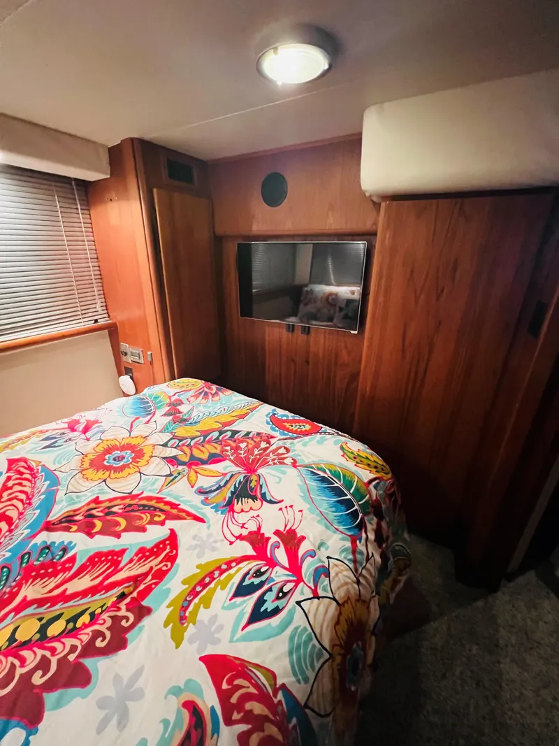 Slide: The Image of Cozy bedroom in 1994 Carver 350 Aft Cabin with vibrant floral bedding. - 33