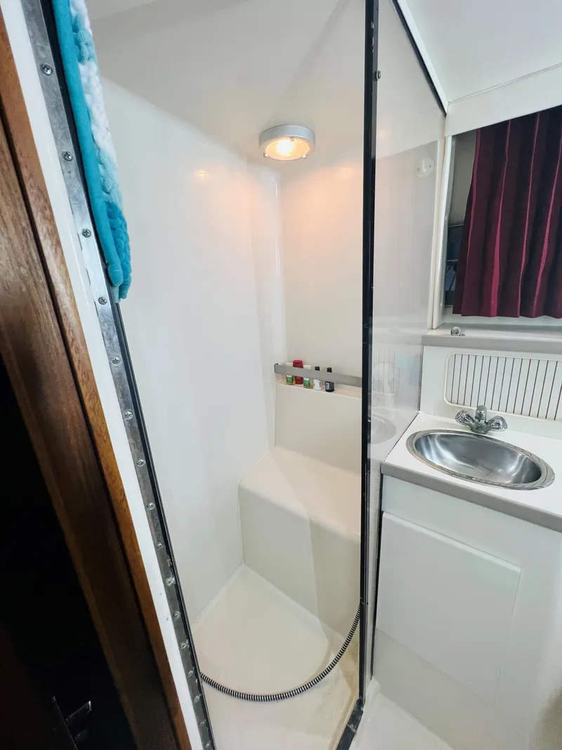 Slide: The Image of 1994 Carver 350 Aft Cabin bathroom with shower and sink. - 35