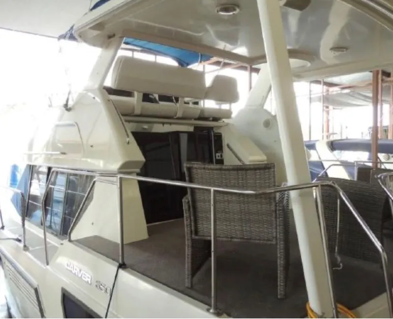 Slide: The Image of 1994 Carver 350 Aft Cabin yacht with spacious deck and seating area. - 4
