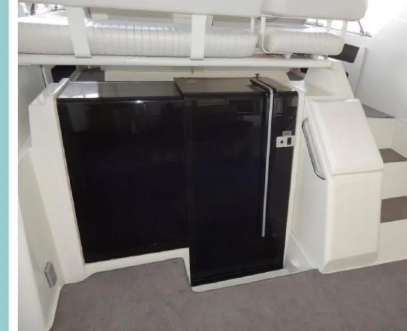 Slide: The Image of 1994 Carver 350 Aft Cabin interior with black cabinetry and stairs. - 7
