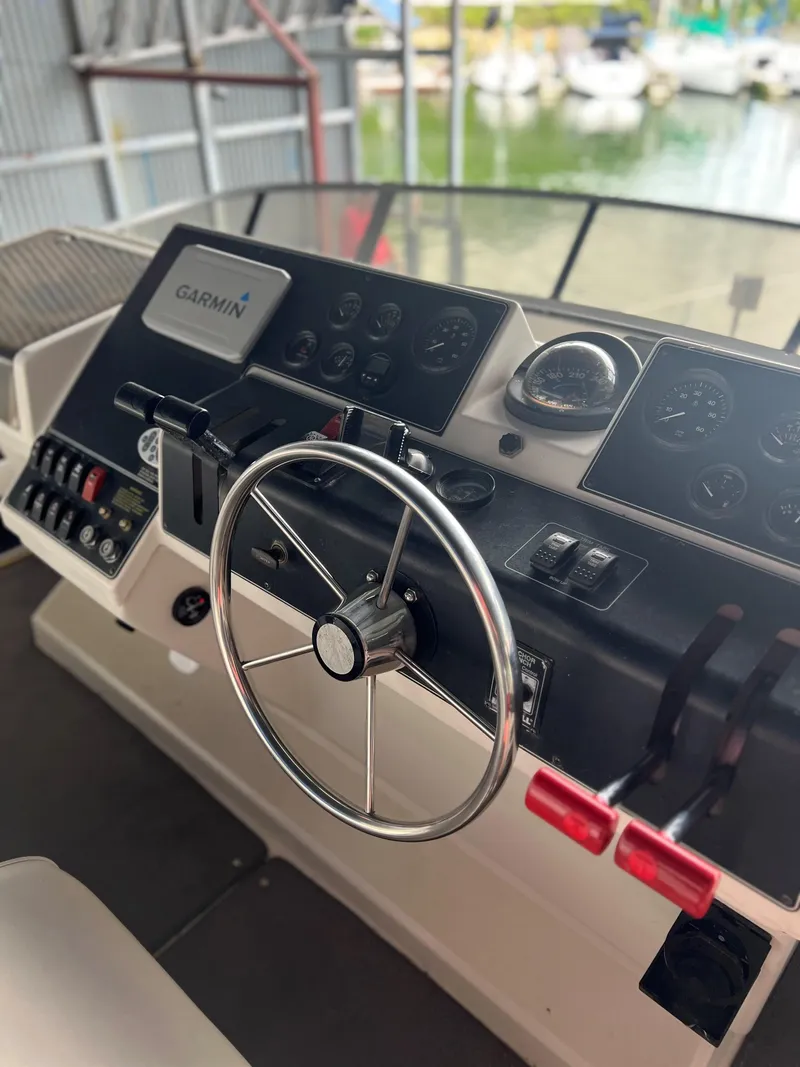 Slide: The Image of 1994 Carver 350 Aft Cabin helm with Garmin navigation system and steering wheel. - 9