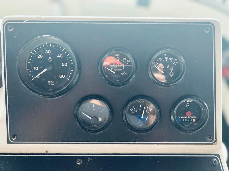 Slide: The Image of Instrument panel of a 1994 Carver 350 Aft Cabin boat showing various gauges. - 15