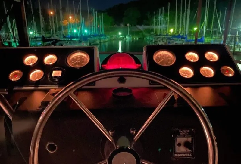 Slide: The Image of Cockpit view of 1994 Carver 350 Aft Cabin at night, illuminated gauges. - 16