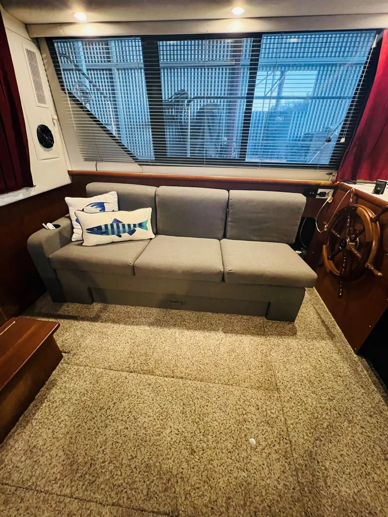 Slide: The Image of Interior of 1994 Carver 350 Aft Cabin with sofa and helm station. - 22