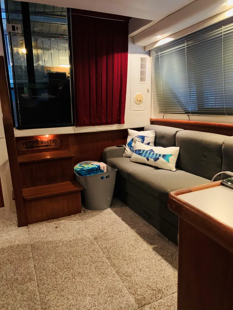 Slide: The Image of Interior of a 1994 Carver 350 Aft Cabin with sofa and decor. - 24