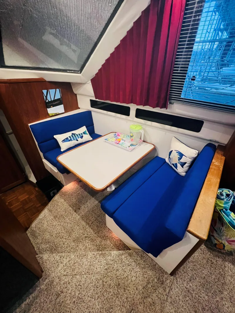 Slide: The Image of 1994 Carver 350 Aft Cabin interior with blue seating and dining table. - 25