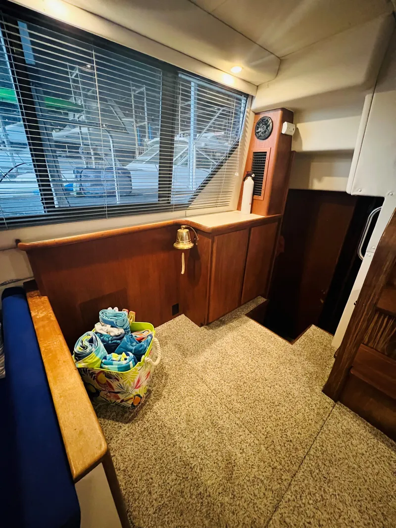Slide: The Image of Interior of 1994 Carver 350 Aft Cabin with wood paneling and nautical decor. - 31