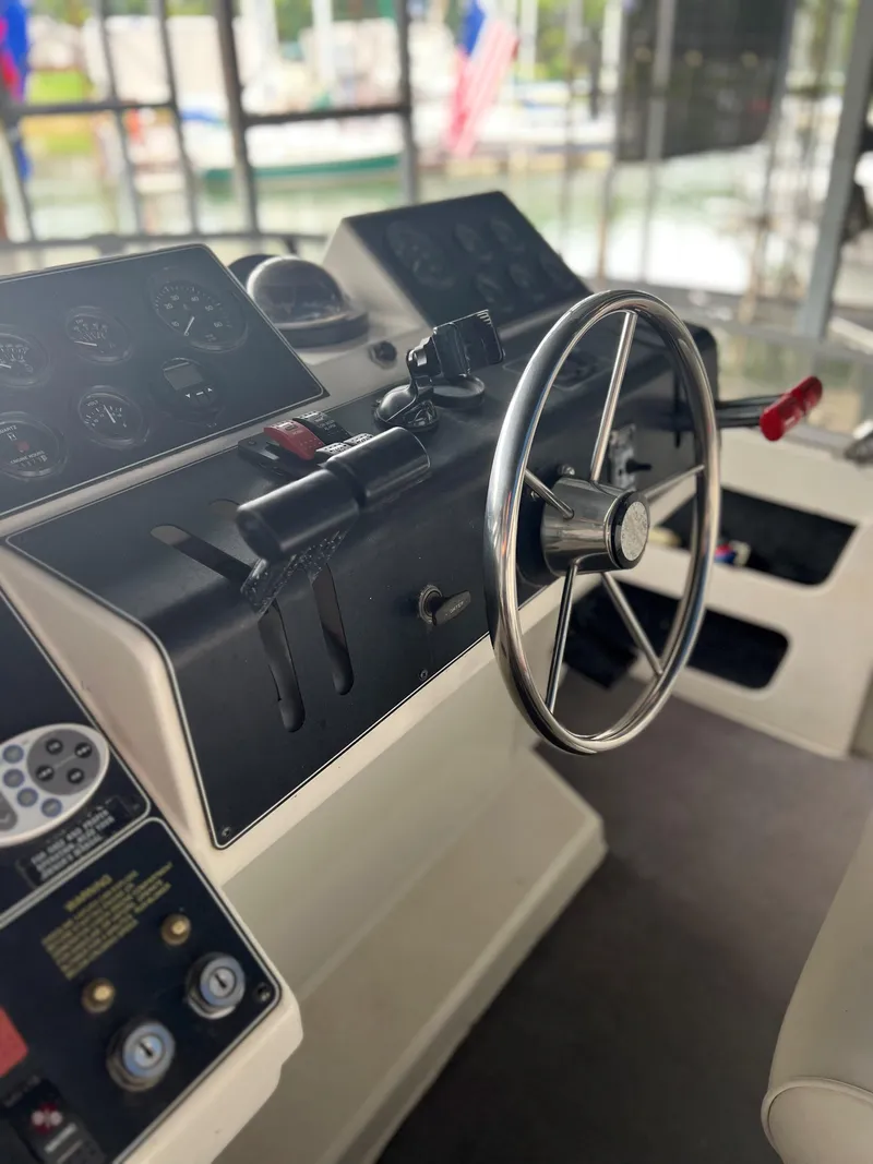 Slide: The Image of 1994 Carver 350 Aft Cabin helm with steering wheel and control panel. - 8