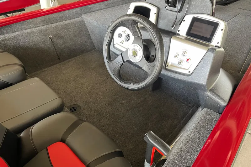 Slide: The Image of Interior of 2025 Tracker Pro Team 190 boat with steering wheel and control panel. - 6