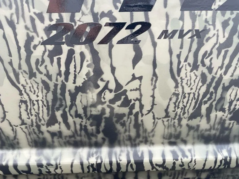 Slide: The Image of Tracker Grizzly 2072 CC 2025 model with camouflage pattern design. - 2