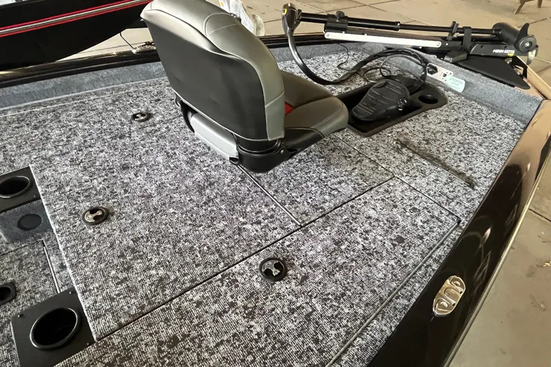 Slide: The Image of 2025 Tracker Pro Team 175 boat interior with gray carpet and seating. - 4