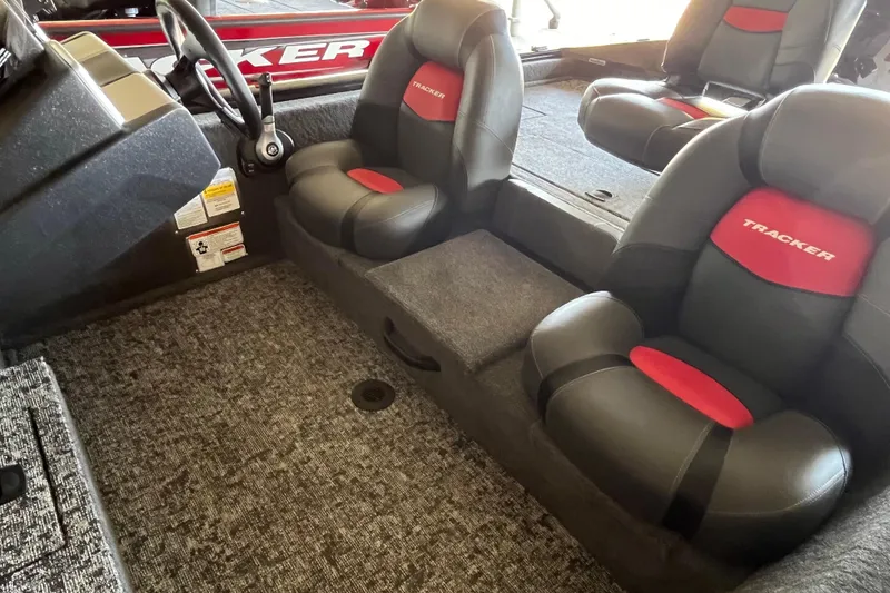 Slide: The Image of 2025 Tracker Pro Team 175 boat interior with black and red seating. - 5