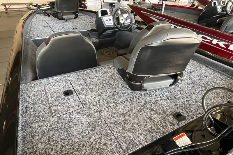 Slide: The Image of 2025 Tracker Pro Team 175 boat interior with gray carpet and dual seating. - 6