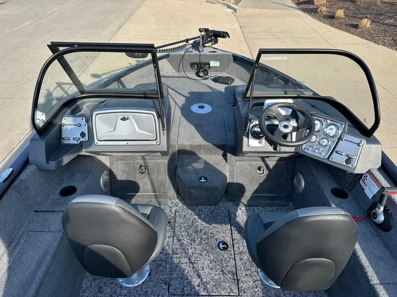 Slide: The Image of 2025 Tracker Pro Guide V-175 Combo boat interior with dual seats and control panel. - 4