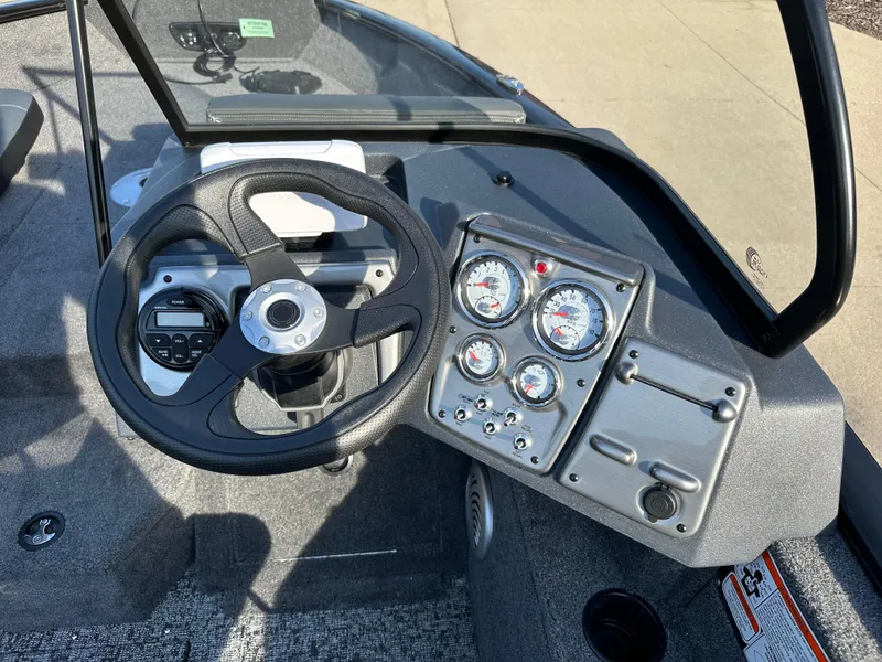 Slide: The Image of 2025 Tracker Pro Guide V-175 Combo boat dashboard with steering wheel and gauges. - 5