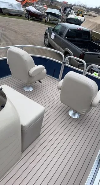 Slide: The Image of 2022 Forester 2208CC boat interior with beige seats and wood-style flooring. - 7