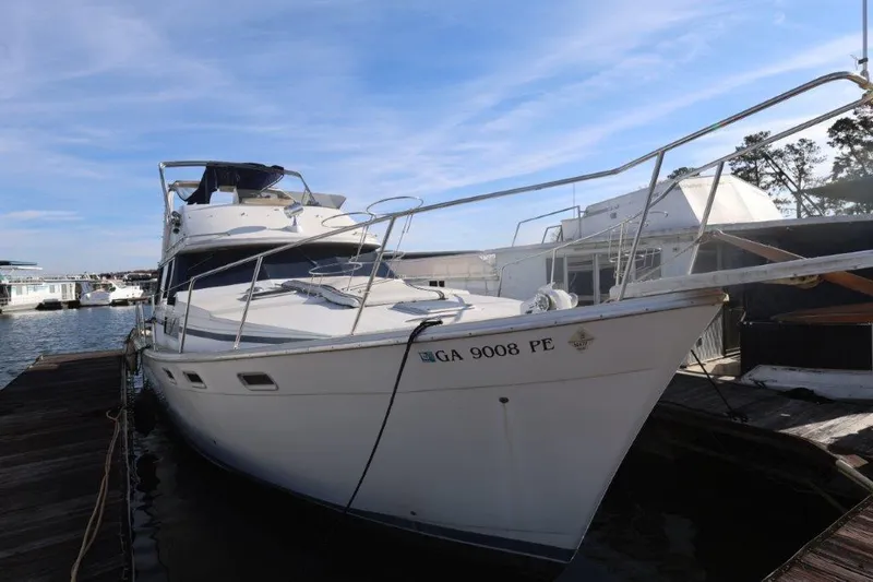 Slide: The Image of 1988 Bayliner 3888 MY Sedan docked at marina under clear blue sky. - 1