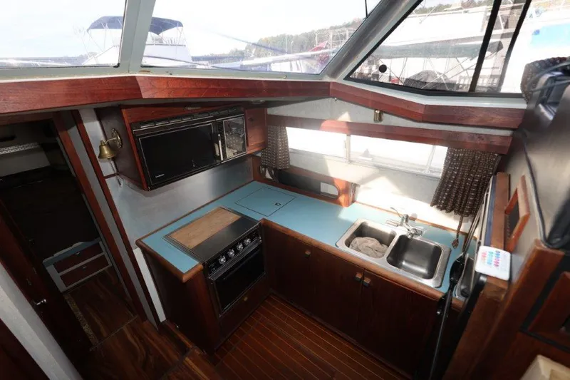 Slide: The Image of Interior of 1988 Bayliner 3888 MY Sedan yacht kitchen with stove and sink. - 12