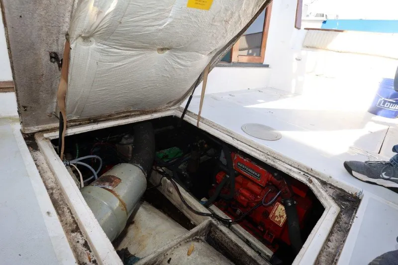 Slide: The Image of Engine compartment of 1988 Bayliner 3888 MY Sedan boat, showing mechanical components. - 15