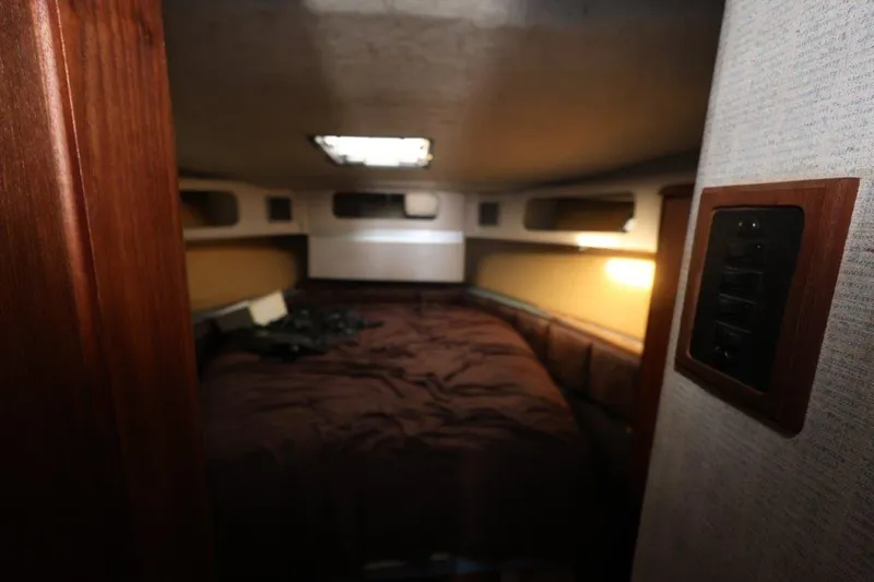 Slide: The Image of Interior cabin of 1988 Bayliner 3888 MY Sedan yacht, featuring cozy sleeping quarters. - 16