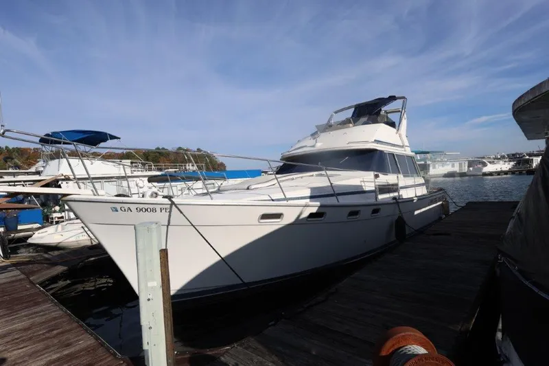 Slide: The Image of 1988 Bayliner 3888 MY Sedan docked at marina under clear sky. - 18