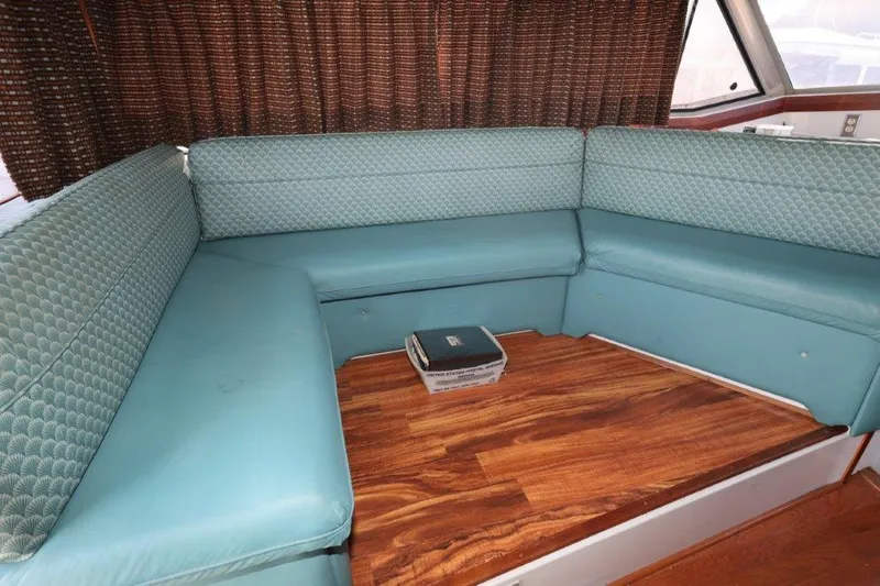 Slide: The Image of Interior of 1988 Bayliner 3888 MY Sedan with teal seating and wooden flooring. - 3