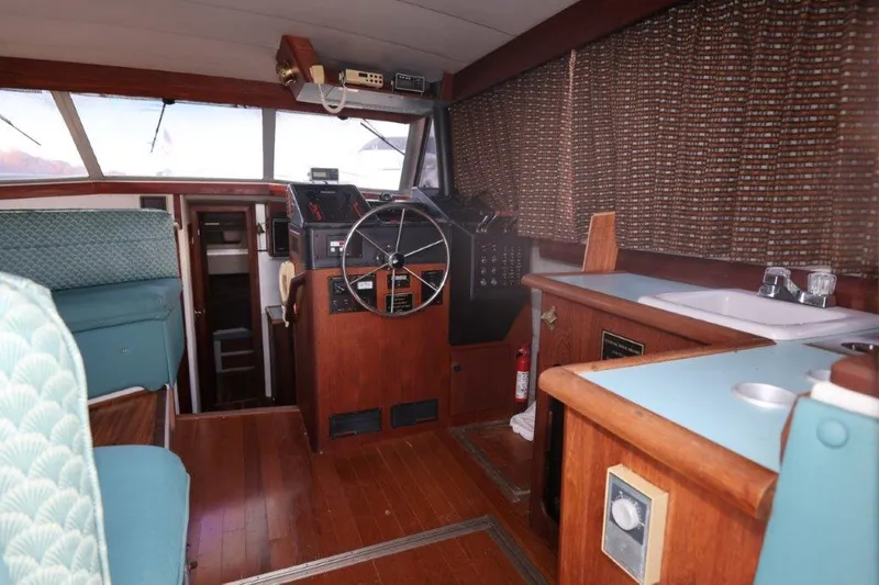 Slide: The Image of Interior of 1988 Bayliner 3888 MY Sedan with wooden flooring and steering wheel. - 5