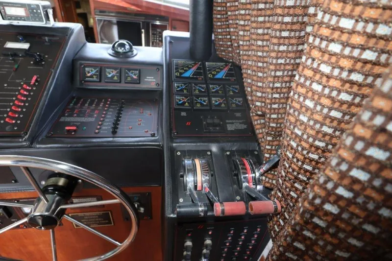 Slide: The Image of Control panel of 1988 Bayliner 3888 MY Sedan boat with steering wheel and gauges. - 6